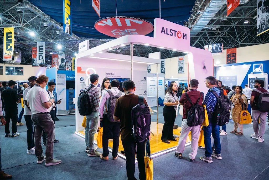 Attendees gathered at a MachineCon AI expo booth